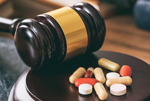 gavel next to pills